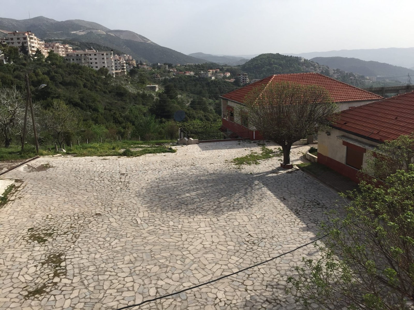 The courtyard between the existing houses, laid in local stone.