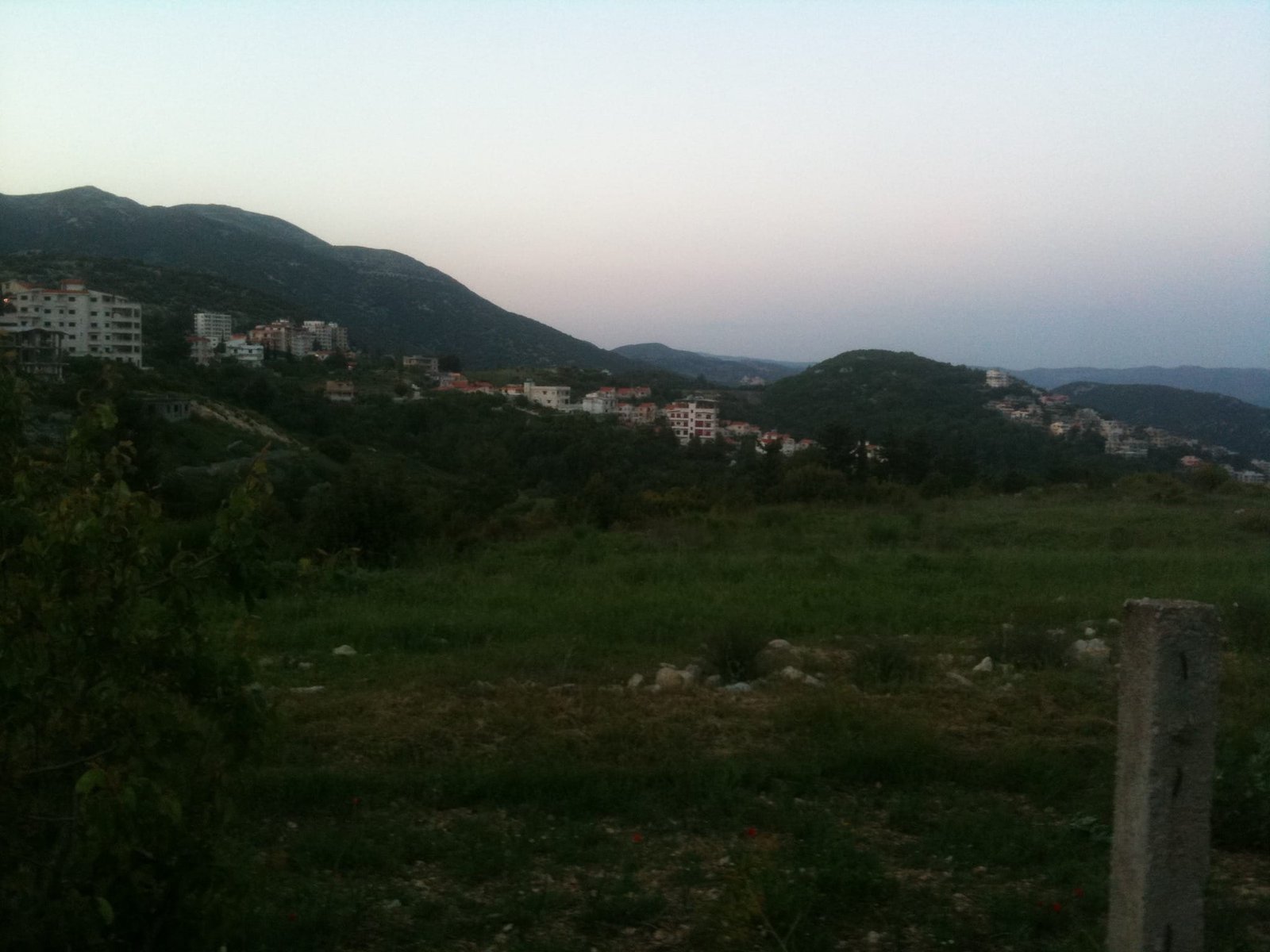 Unbuilt ground on the northern parcel, with the town beyond