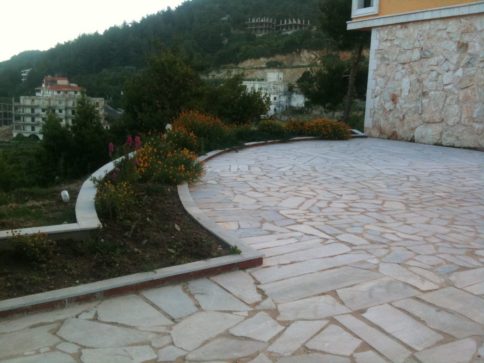 The stone path between the villa and the lower buildings